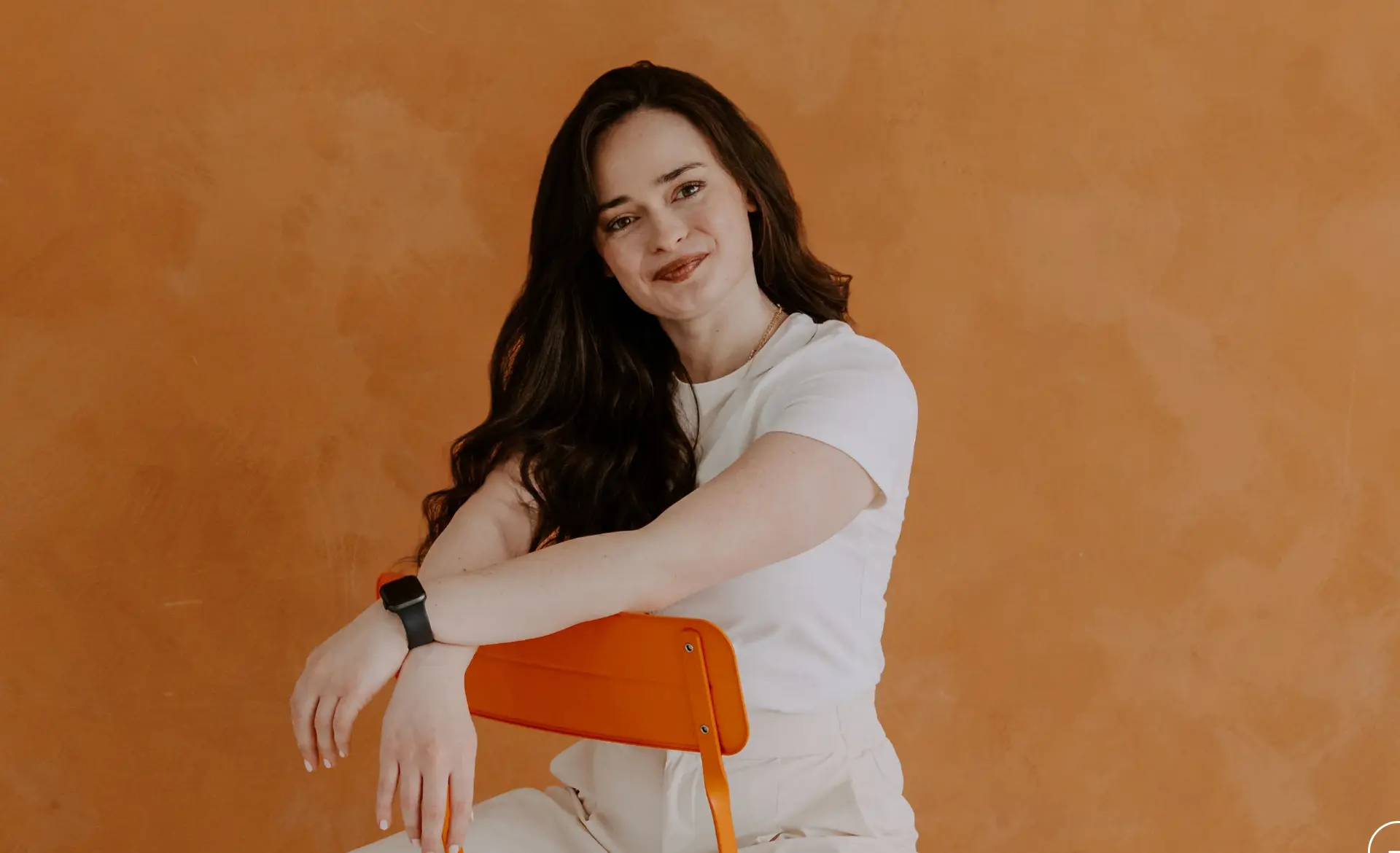 Portrait of the founder of Empaithy Automations against a warm terracotta wall